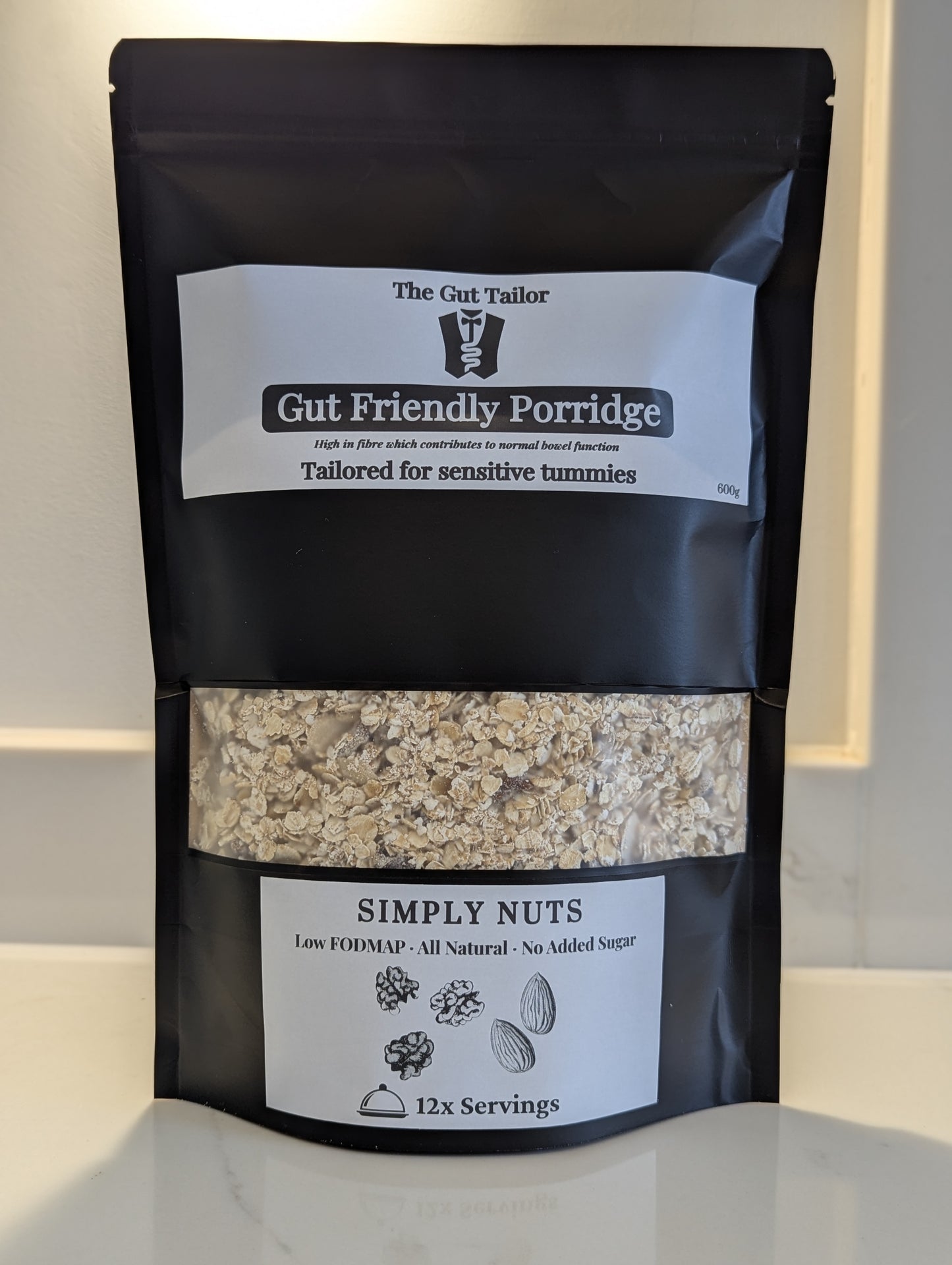 Black package of Gut Friendly Porridge with visible contents on a light background