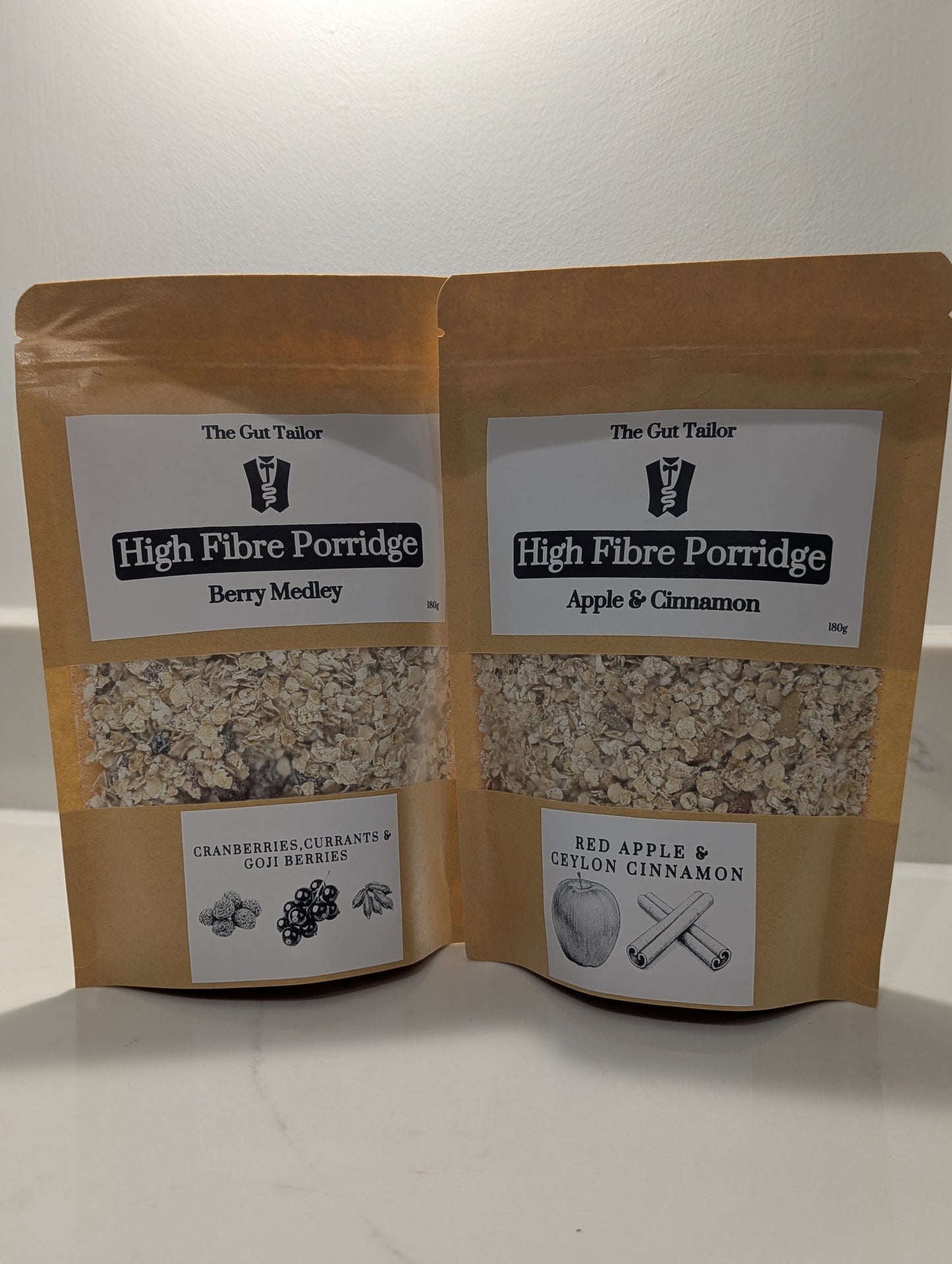Two packages of High Fibre Porridge from The Gut Tailor on a white background