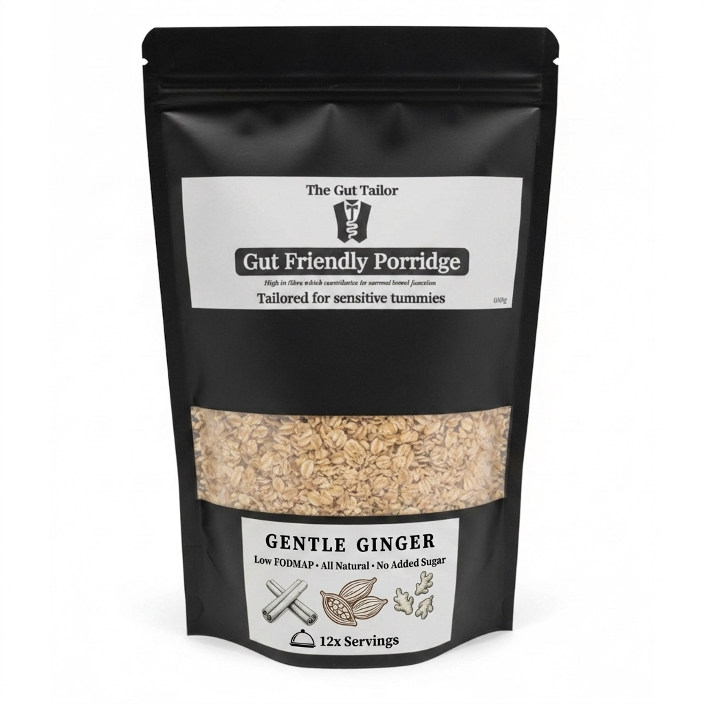 A black stand-up pouch of 'The Gut Tailor' Gut Friendly Porridge, Gentle Ginger flavor, with a clear window showing the beige oatmeal inside. The packaging features white labels with black text and illustrations.