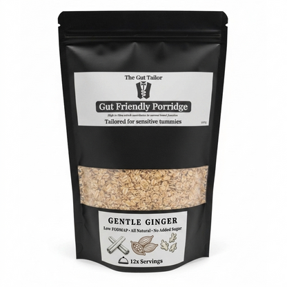 A black stand-up pouch of 'The Gut Tailor' Gut Friendly Porridge, Gentle Ginger flavor, with a clear window showing the beige oatmeal inside. The packaging features white labels with black text and illustrations.