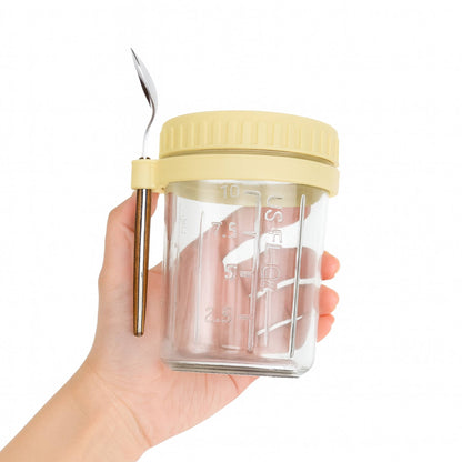 Overnight oats jar for high fibre healthy breakfast meal prep yellow lid and strap with spoon holder.